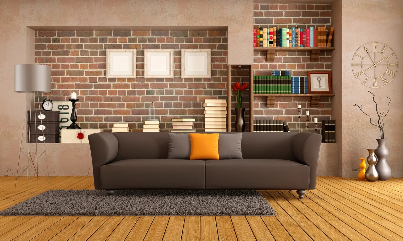 A living room with a couch and brick wall