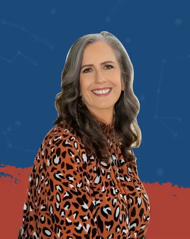 A woman in leopard print shirt smiling for the camera.