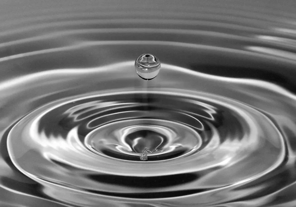 A water drop falling into the water